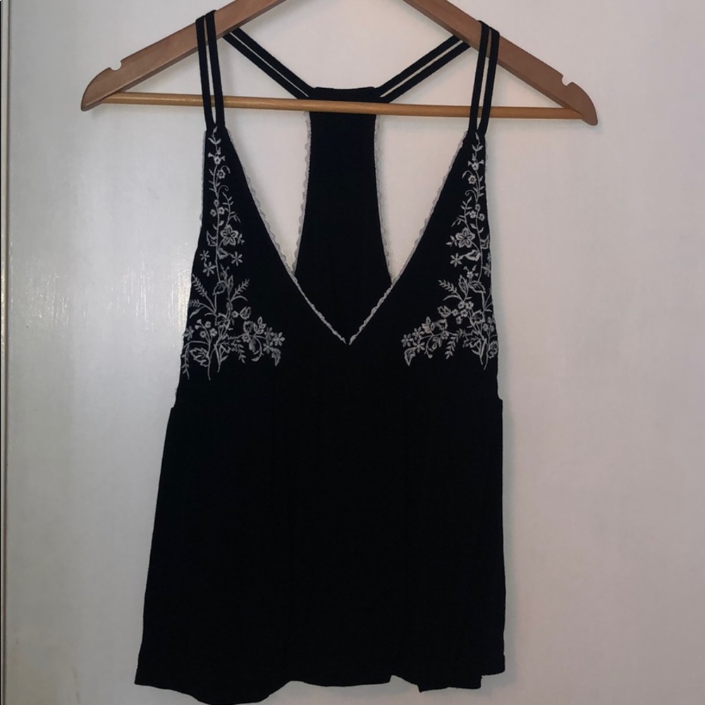 Black, flowy tank top with floral print.